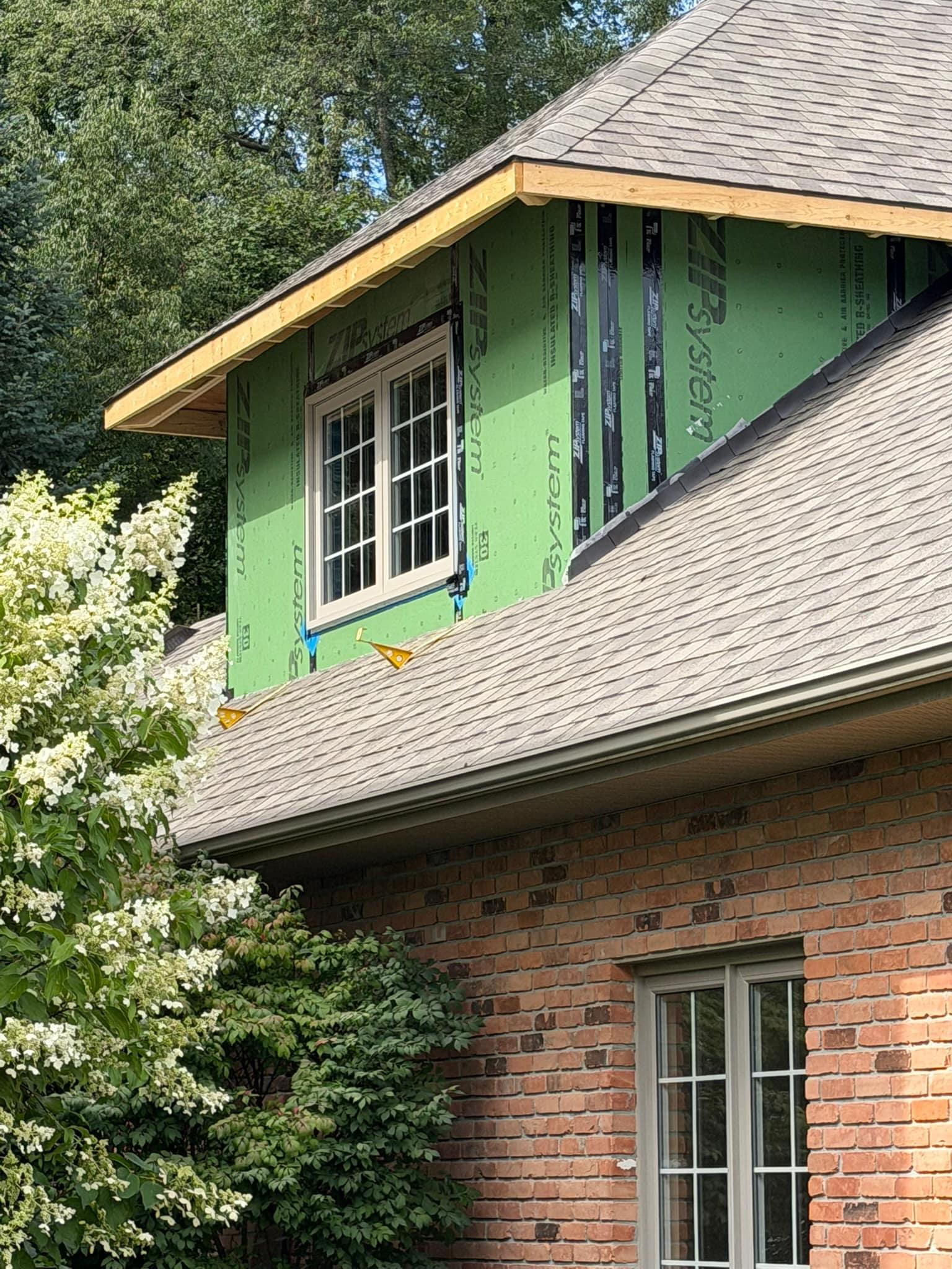 New dormer window from outside, matched to the existing windows on the house