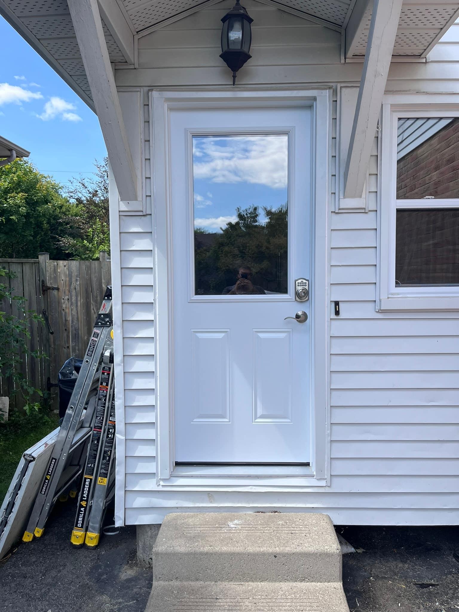 New steel side entry door with vinyl siding