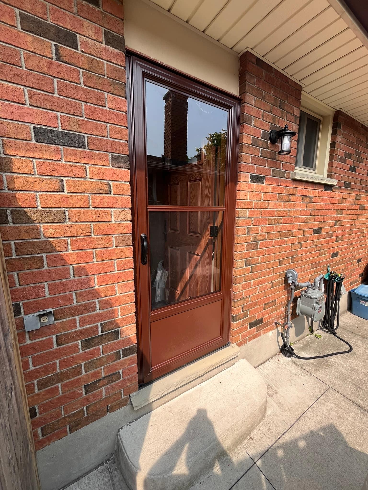 Storm door fitted to a brick entry