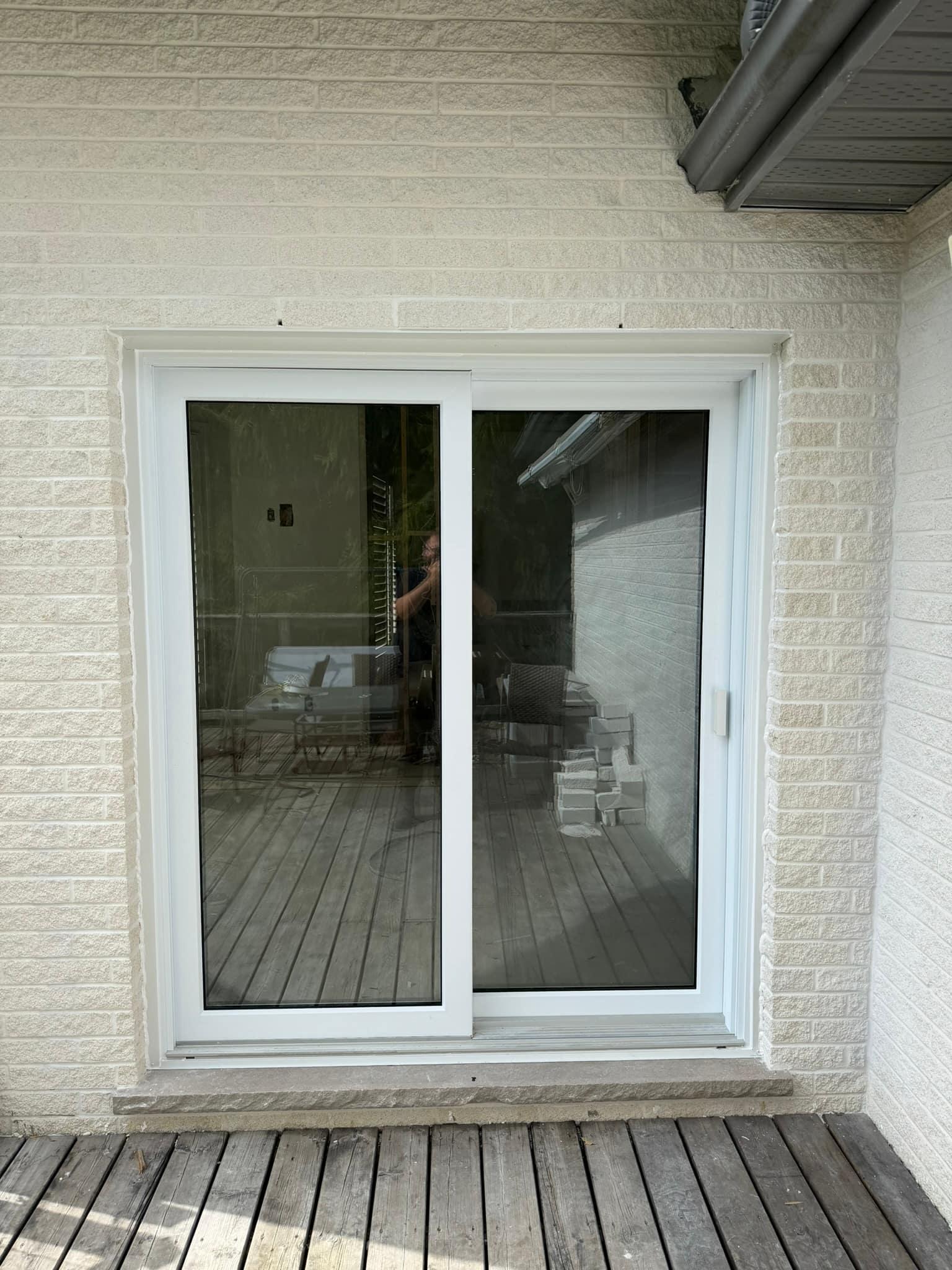 New sliding patio door on a painted-brick house